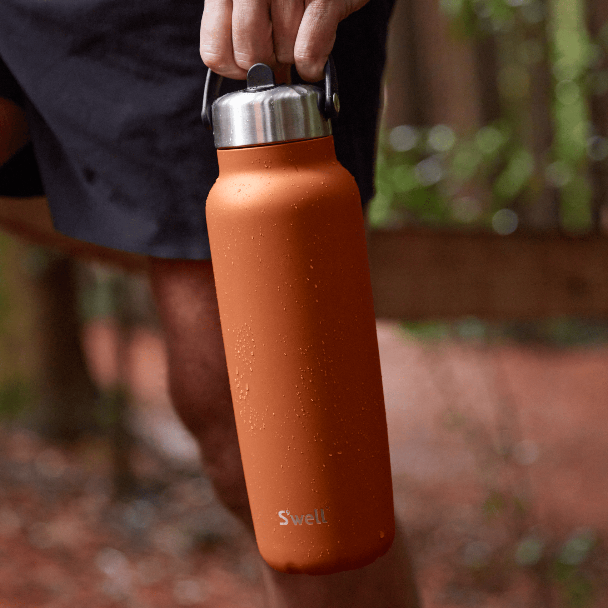 explorer-with-flip-straw-lid-40oz-h6 Swell-Explorer-Water-Bottle-40oz-Orange-Carnelian-LifeStyle.png